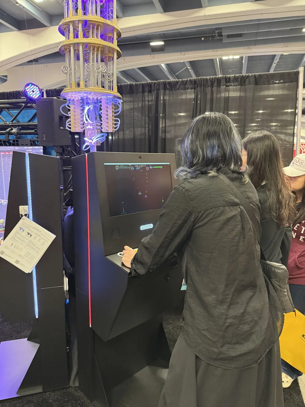 An attendee playing Bloch Invaders on the Quantum Arcade cabinet at GDC 2026
